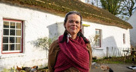 A woman dressed in historical costume at the Folk Park
