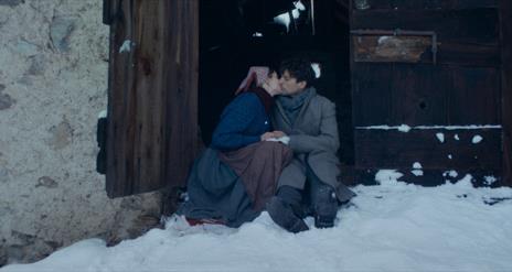 Man and women sitting in snow