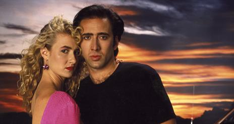 man and woman looking at camera