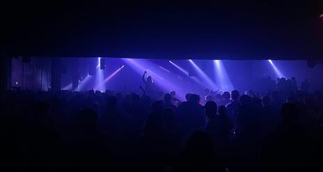 Large crowd dancing in club setting