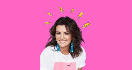 Deirdre Okane is in front of a pink background, wearing a white tshirt with small cartoon lightening bolts around her head