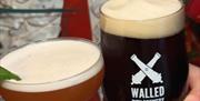 A cocktail and stout beer chearsing from Walled City Brewery