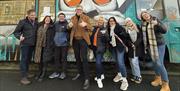 Group shot outside of pyke n pommes double decker bus restaurant