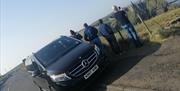 Legenderry Chauffeurs with group at Dunluce Castle
