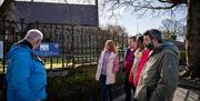 Walking tour group on a stop in Derry~Londonderry with guide David from Derrie Danders