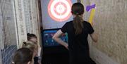 Kids enjoying the Velcro Axe Throwing option at Tactixs Adventure Centre