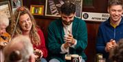 Group of people enjoying Irish music in a pub