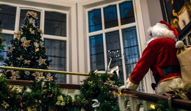 Santa walking up the stair's in the Bishop's Gate Hotel.