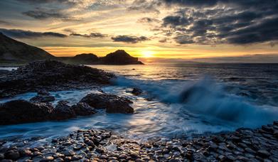 waves lap over the basalt stones at the giants causeway