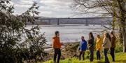 Guided tour on the banks of the River Foyle, looking at the Foyle Bridge. Brook Hall Estate & Gardens, Derry~Londonderry.