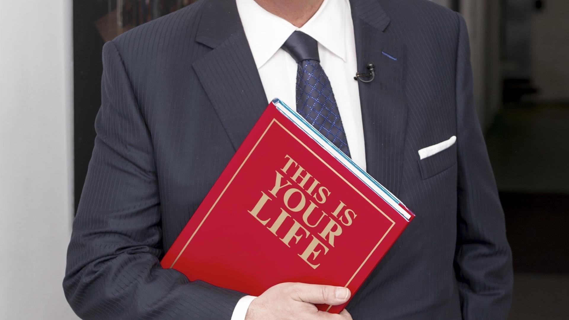 Picture of Eamon Holmes with a red book. Picture of Eamon Holmes with a red book.