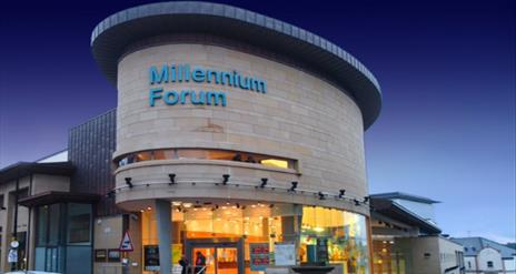 Millennium Forum exterior at night.