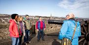 Group on the walls beside a cannon in Derry~Londonderry with guide David from Derrie Danders