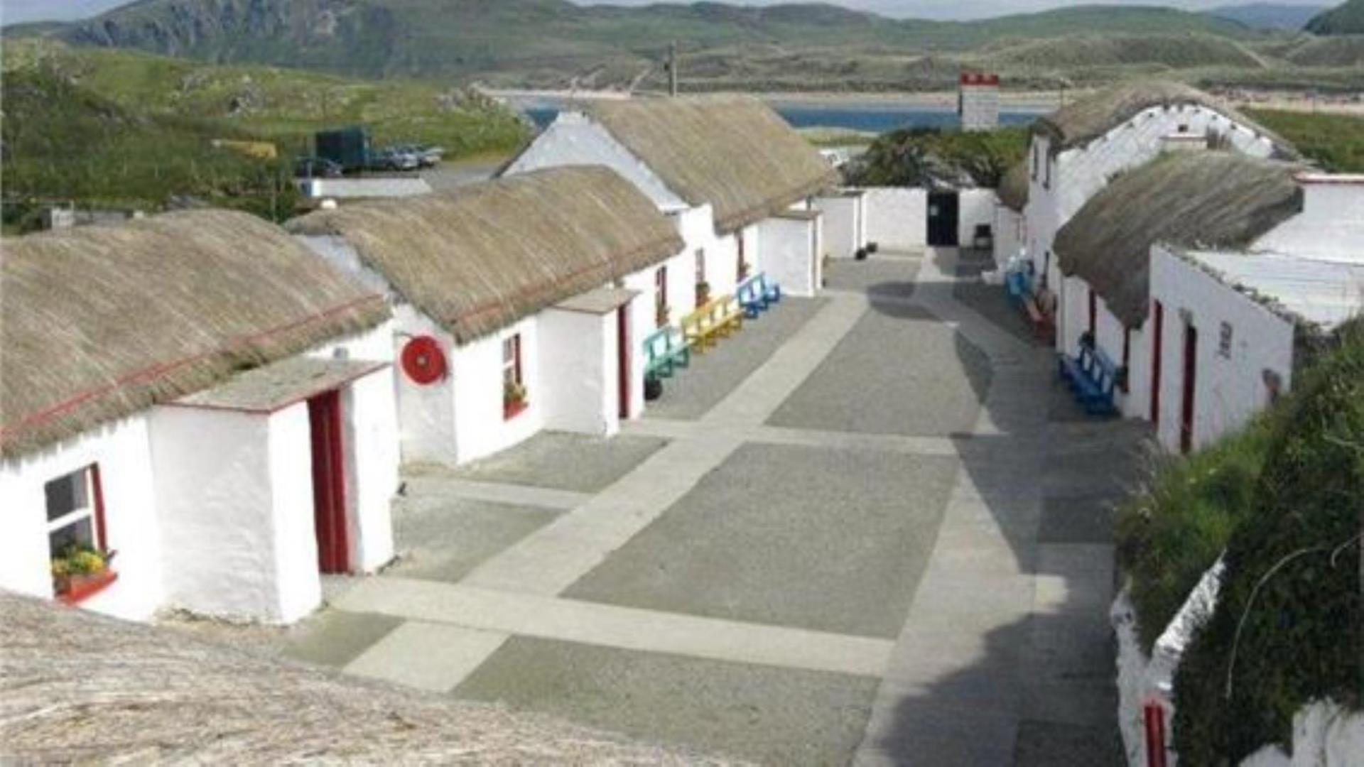 A set of thatched cottages within a village