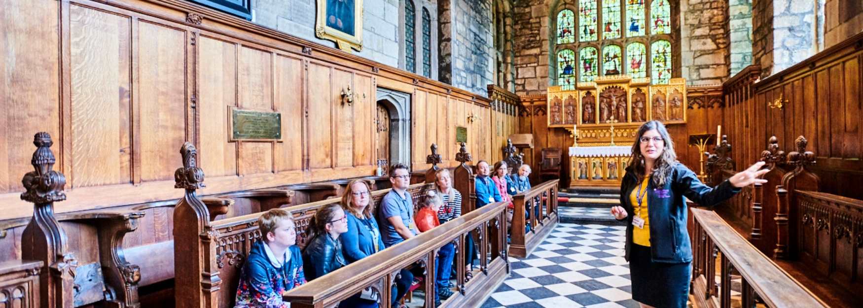 Someone leading a guided tour in Durham Castle