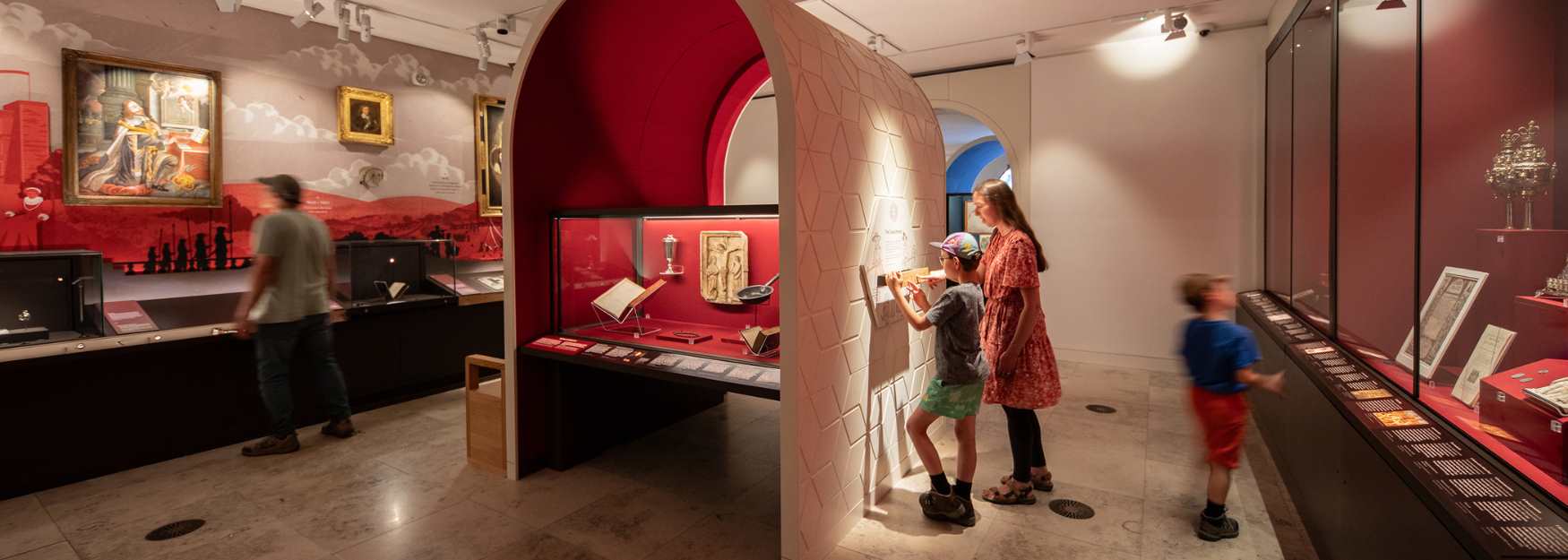 Children and visitors looking at exhibits on display in a museum