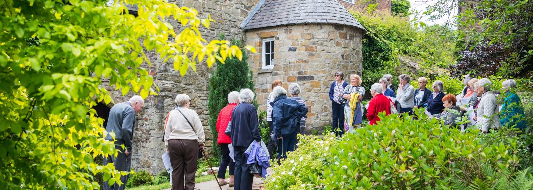 A group of people looking around Crook Hall and Gardens