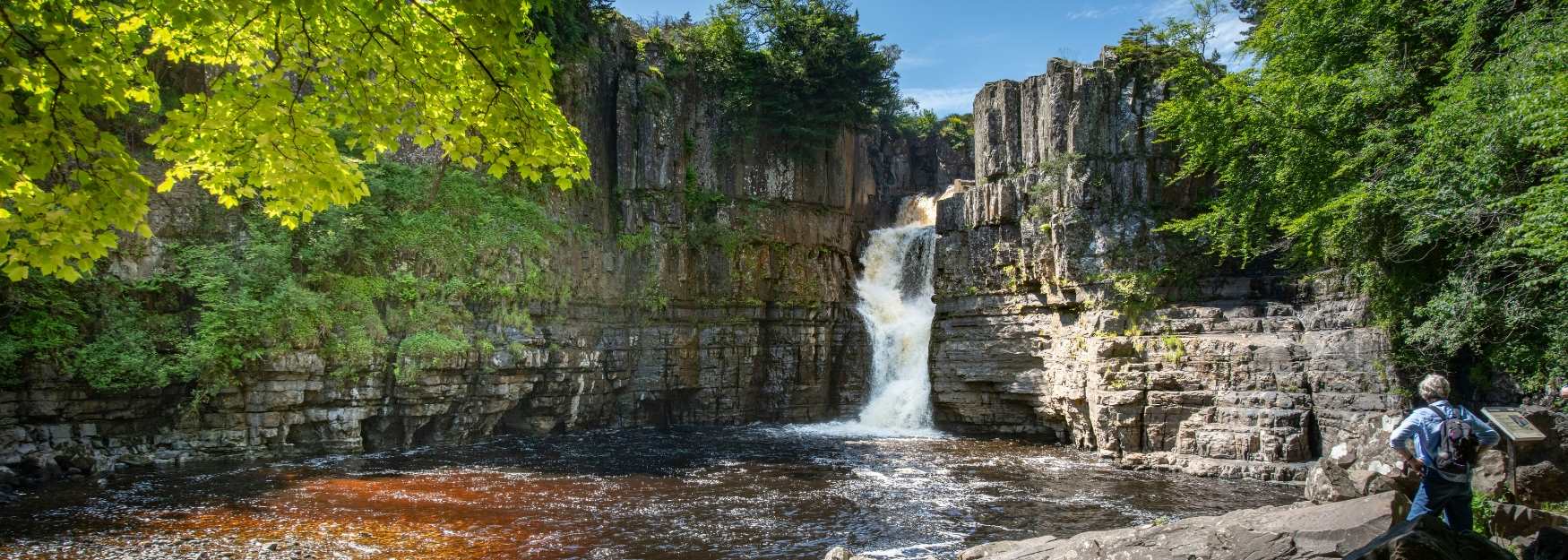 A man watching High Force waterfall