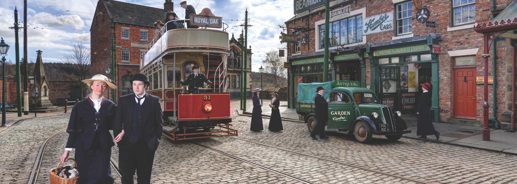 People in costume at Beamish Museum in front or the trams