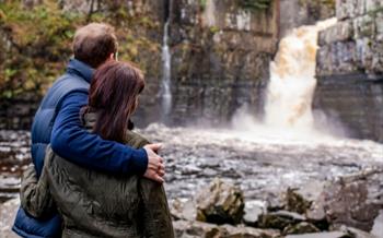 A couple looking at High Force Waterfall