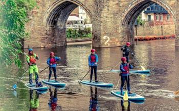 Adventure Access people paddle boarding in Durham