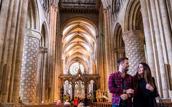 A couple walking around Durham Cathedral