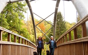 A mum and daughter walking their dogs at Hamsterley Forest
