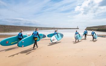 A group of people paddleboarding at Seaham