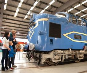 A family looking at a train at Locomotion