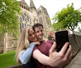 A couple taking a selfie at Durham Cathedral