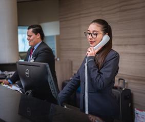 Two people at a reception desk