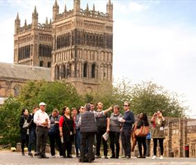 A group of people outside of Durham Cathedral