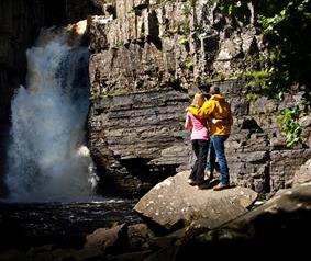couple at high force waterfall