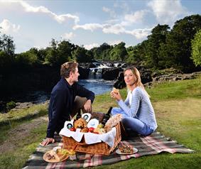 couple enjoying a picnic at Low Force Waterfall.
