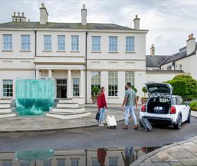 Two people getting out of a car at Seaham Hall Hotel