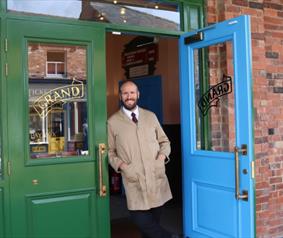 A man outside a shop at Beamish