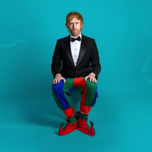 Mark Simmons dressed in a dinner jacket with Jester's trousers and shoes