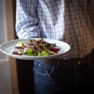 Waiter serving food at Lord Crewe Arms