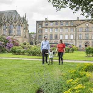 A family walking in the grounds of Ushaw 
