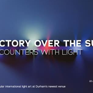 Text reads, 'Victory Over The Sun Encounters with Light' against a multicoloured background of light emerging from darkness.  
