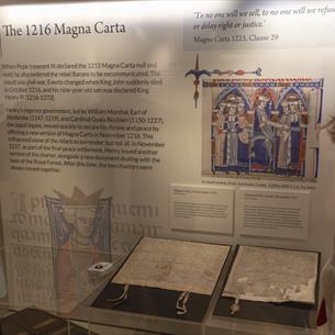 Two people looking at the 1216 Magna Carta at Durham Cathedral Museum