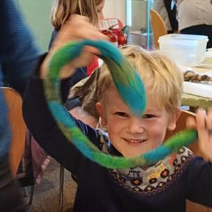 Boy holding felt snake