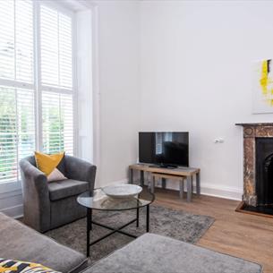 Lounge area with large window and fireplace