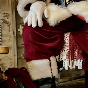 Close up of Santa's legs sitting on a chair.