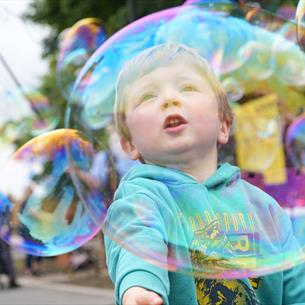 A child playing with bubbles at Hopetown Darlington.