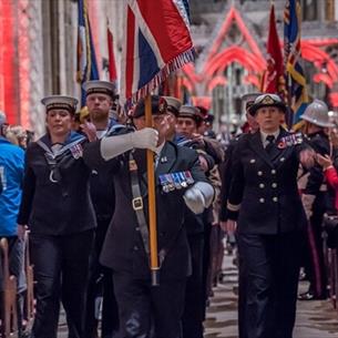 Festival of Remembrance service in Durham Cathedral with members of the armed forces marching down the Nave with the Union Jack held high