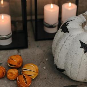 A decorated pumpkin and candles