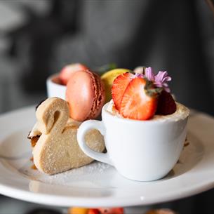 An example of the afternoon tea Café Bowes makes featuring macaroons, scones and swan style biscuit.