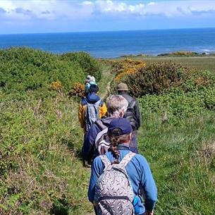 A group of people walking on the east Durham coast