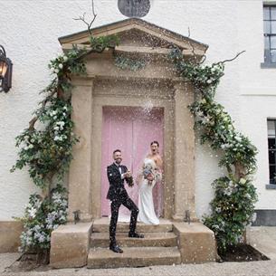 Wedding couple on the doorstep of the hotel